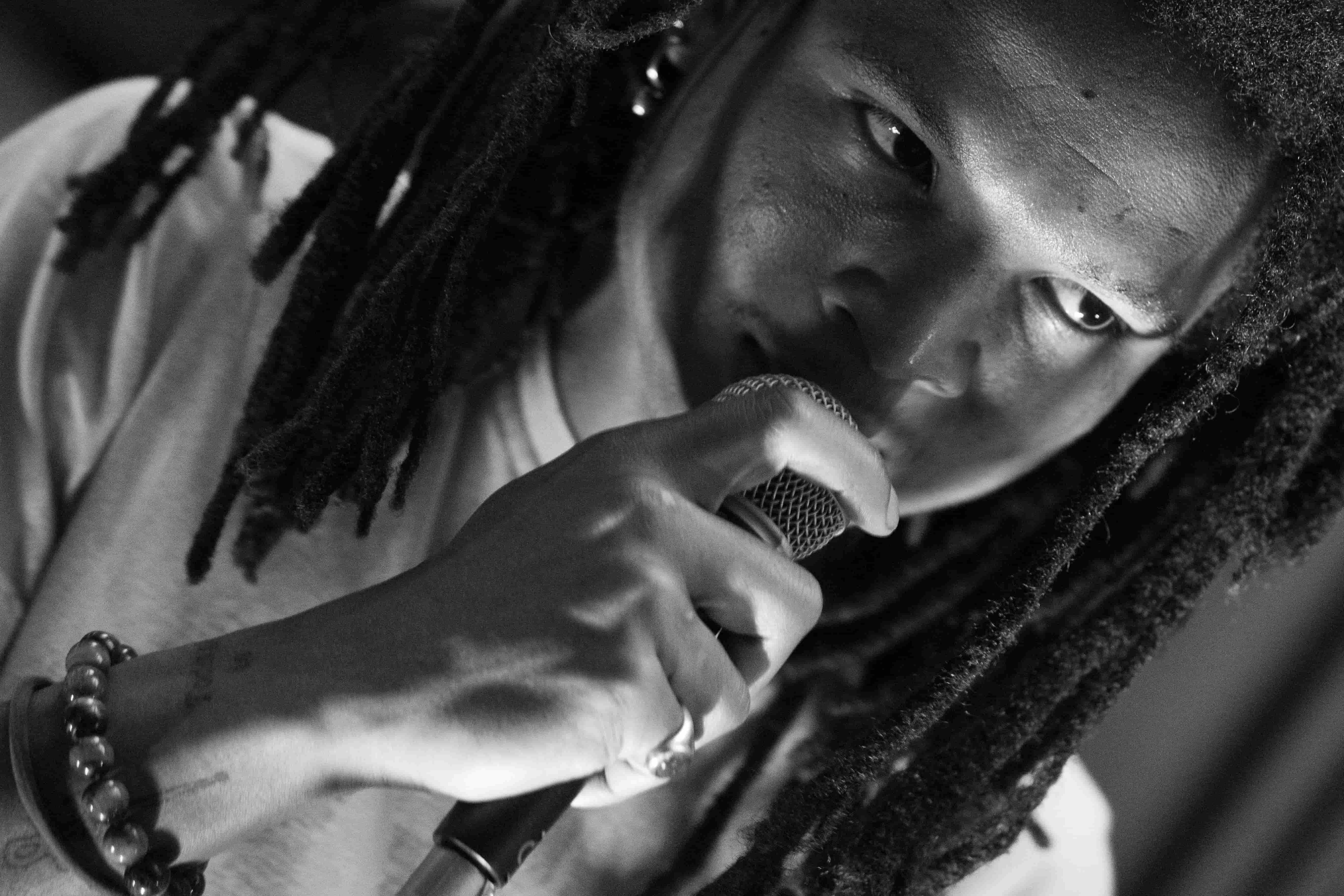 Close-up of Fabian Selote at microphone, black and white