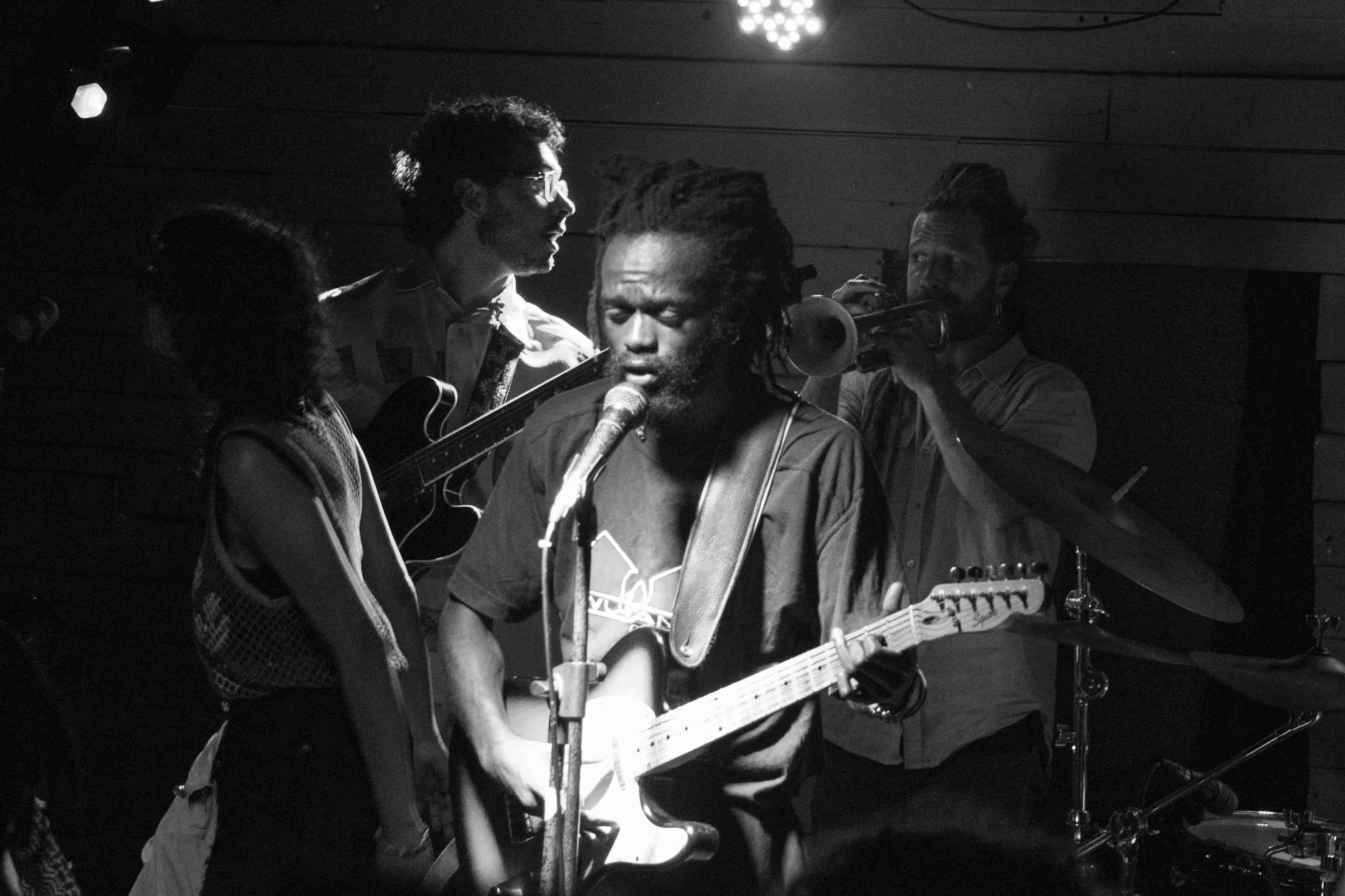 Sanele Blaai and band performing, black and white