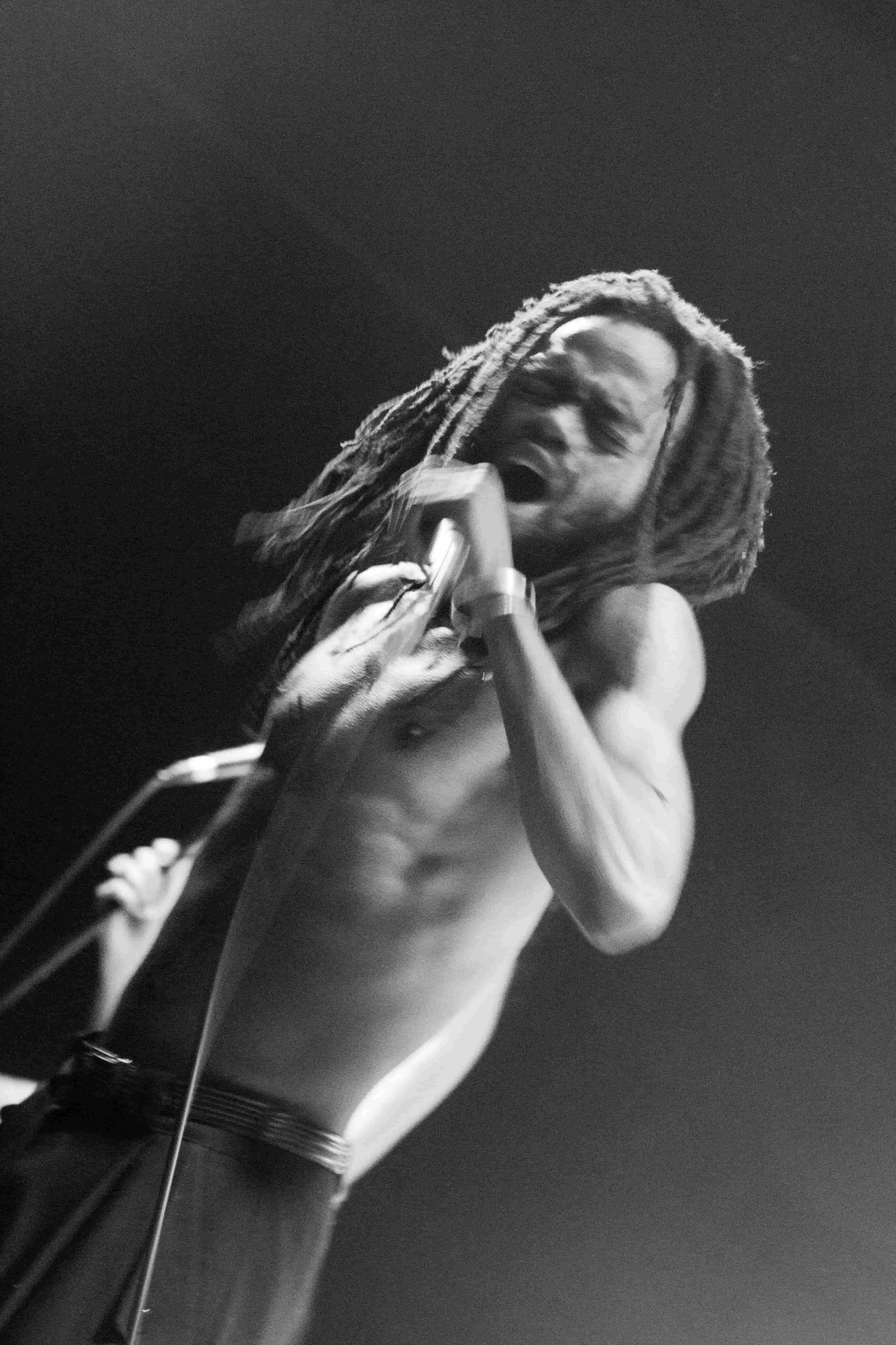 Sanele Blaai holding microphone, dramatic black and white